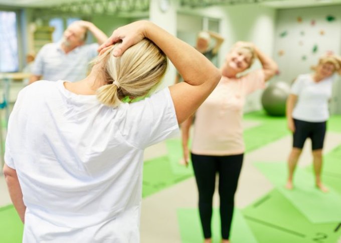 Seniorzy na ćwiczeniach wzmacniających i rozciągających pomagających zadbać o kręgosłup